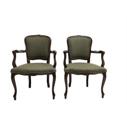Pair French style stained beech elbow chairs, the cresting rails carved with flower heads, mould arms with scrolled terminals, upholstered in green woollen herringbone fabric, floral carved cabriole supports