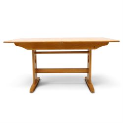 Ercol - 'Windsor' ash medium extending dining table, with stowed fold over leaf extending to 200cm, shaped supports with roundel aperture, united by a stretcher