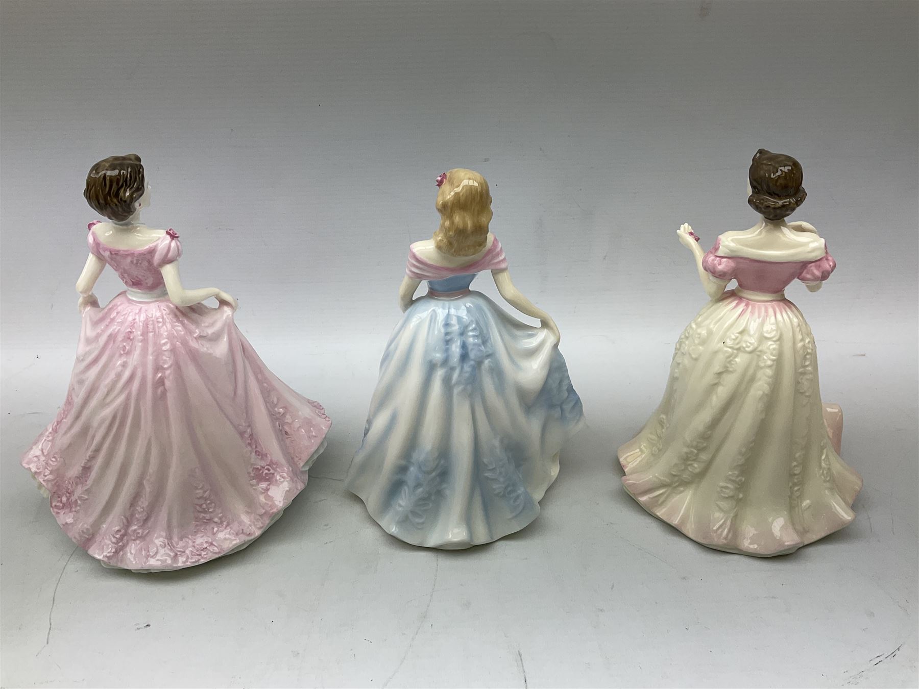 Three Royal Doulton figures, comprising Faith HN4151, Hope HN4097 and Charity HN4243, together with a horse and foal figure group