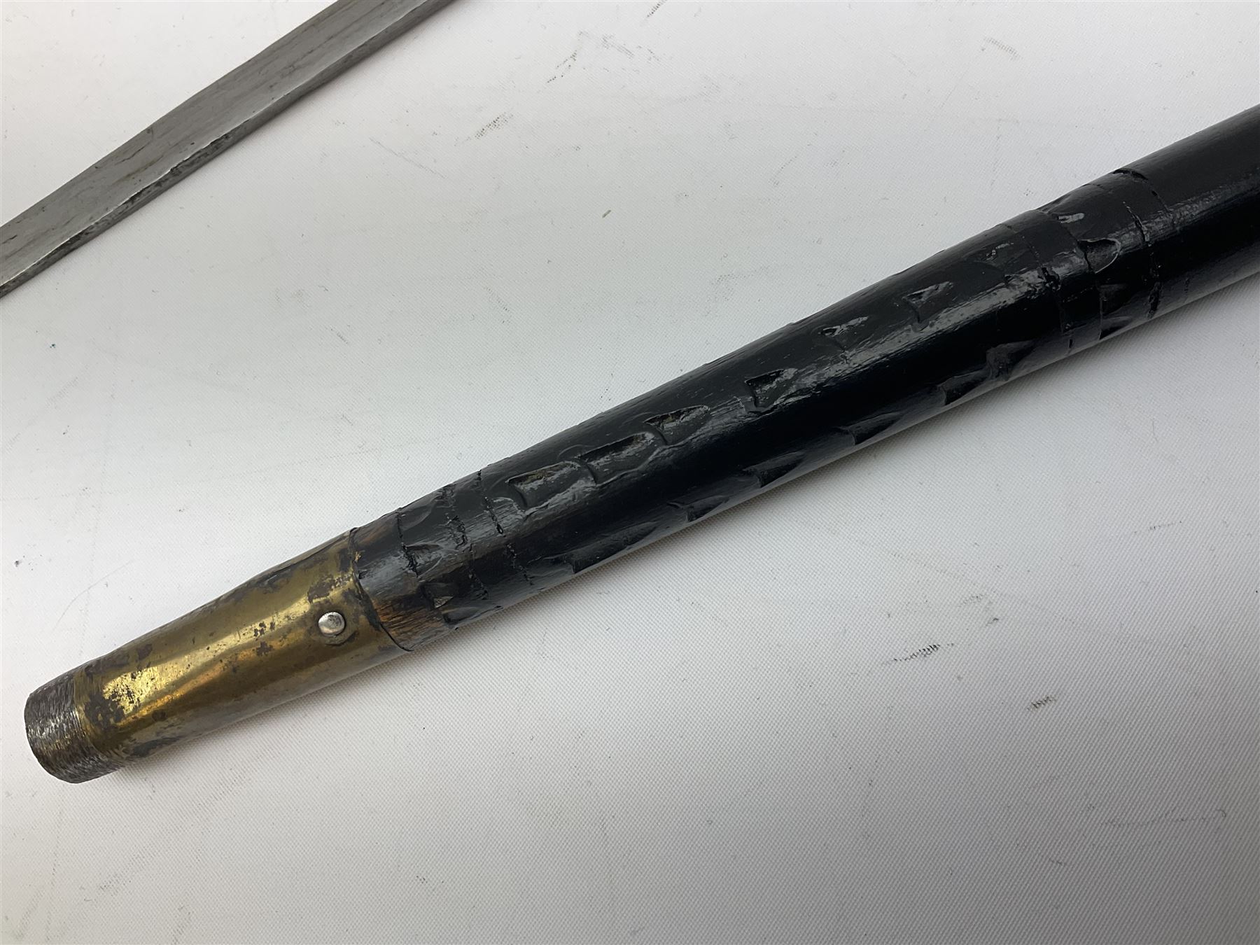 
Late 19th/early 20th century Anglo Indian ebony and bone sword stick with 62cm steel blade, brass locking ferrule and lion mask pommel L92 cm.