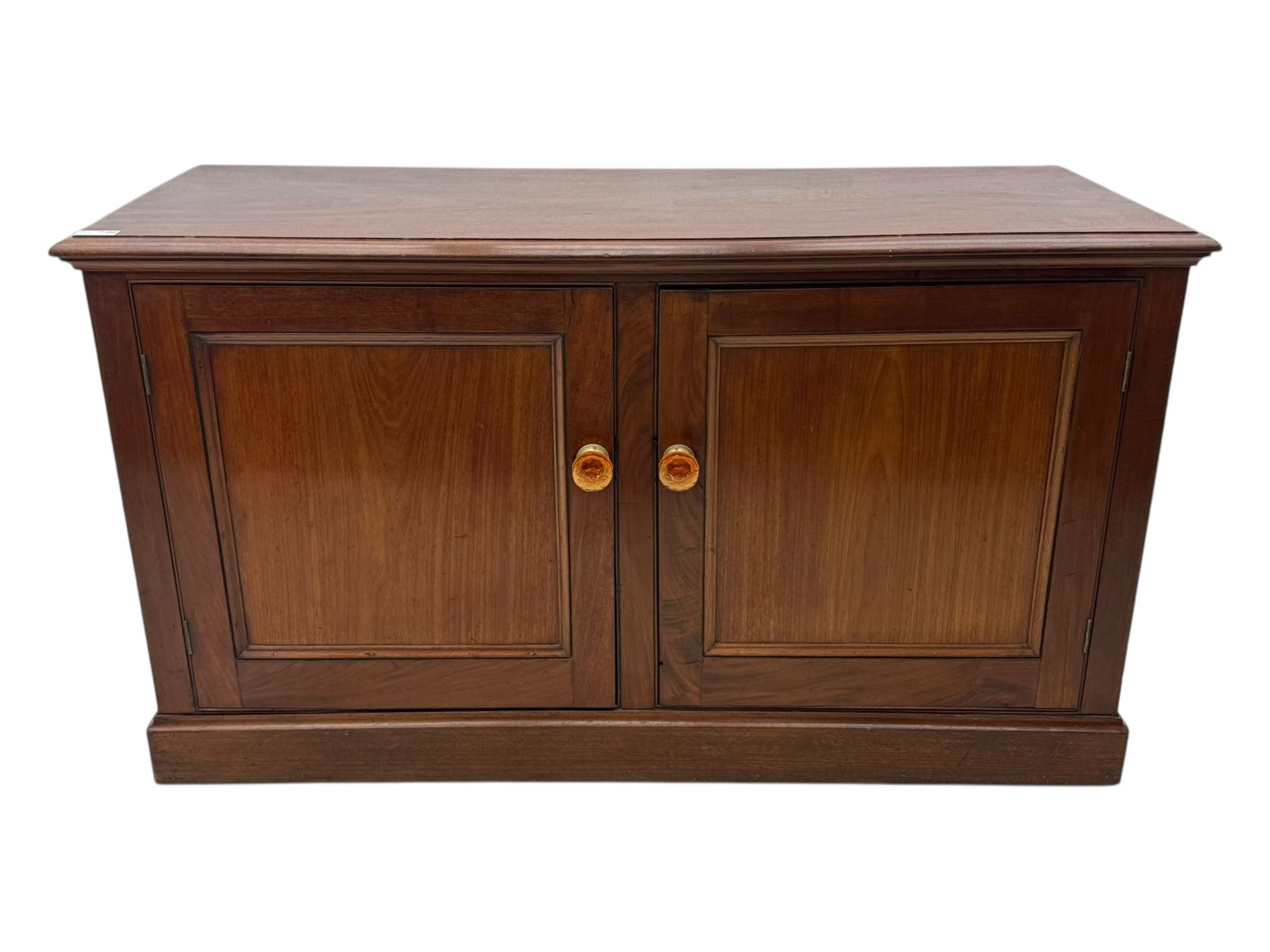 Victorian mahogany cupboard, plain rectangular top above two fielded panel doors opening to shelved interior, raised on a moulded plinth base, with later replacement knob handles