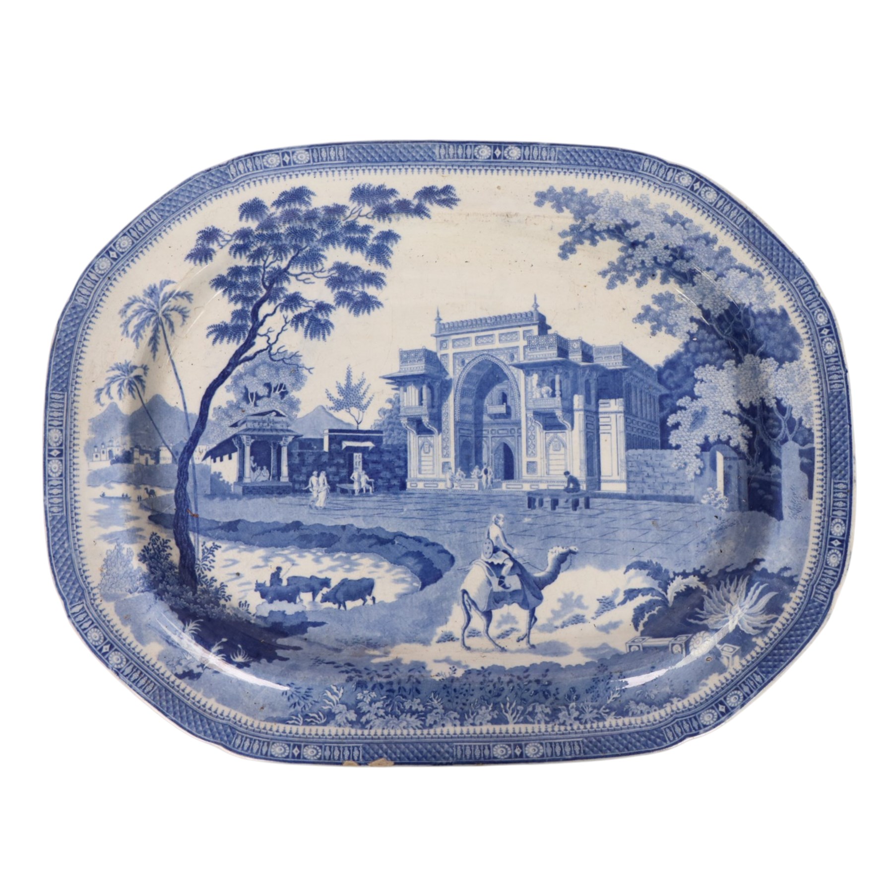 Early 19th Century Spode Caramanian series serving dish, printed in blue and white with the Triumphal Arch at Tripoli in Barbary, reserved within a running border of Indian sporting animals, together with Rogers Camel pattern platter and plate, Adams Lions plate and Davenport platter, largest platter L43cm 