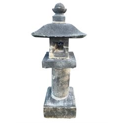 Japanese tea garden lantern in stone, pagoda top with finial on rectangular open lamp, cylinder column decorated with Japanese script, square plinth base