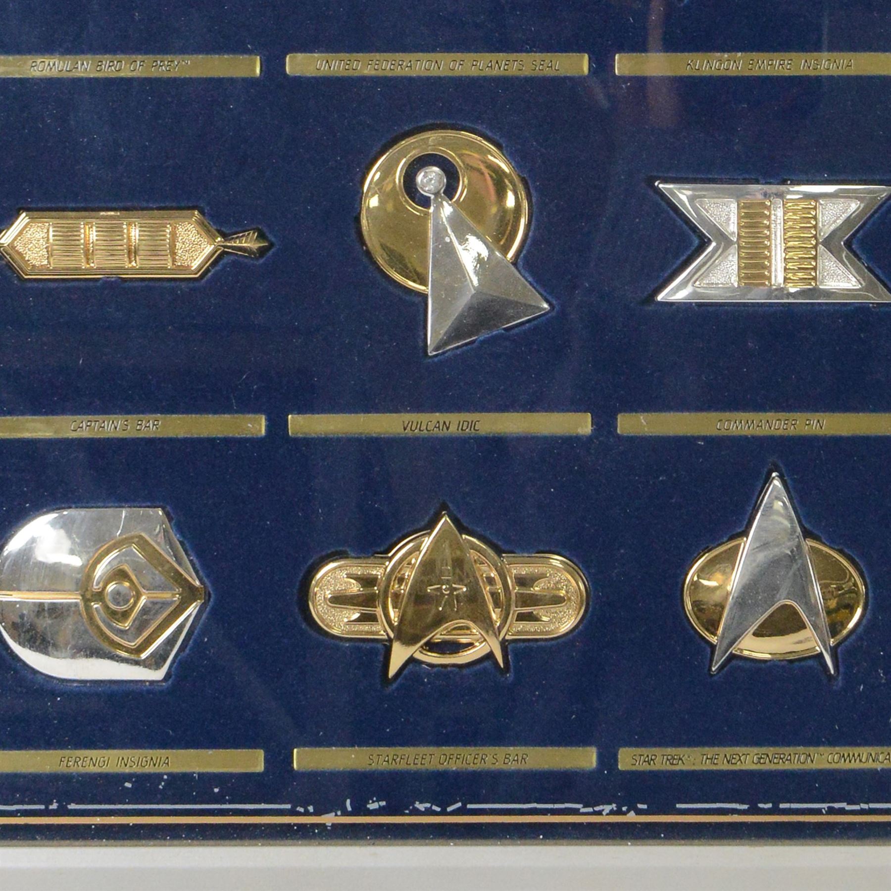 Franklin Mint The Official Star Trek Insignia Collection, set of twelve sterling silver insignia with gold plated decoration, all stamped 925 sterling with certificates of authenticity, contained within a wooden glazed display case, case H56cm