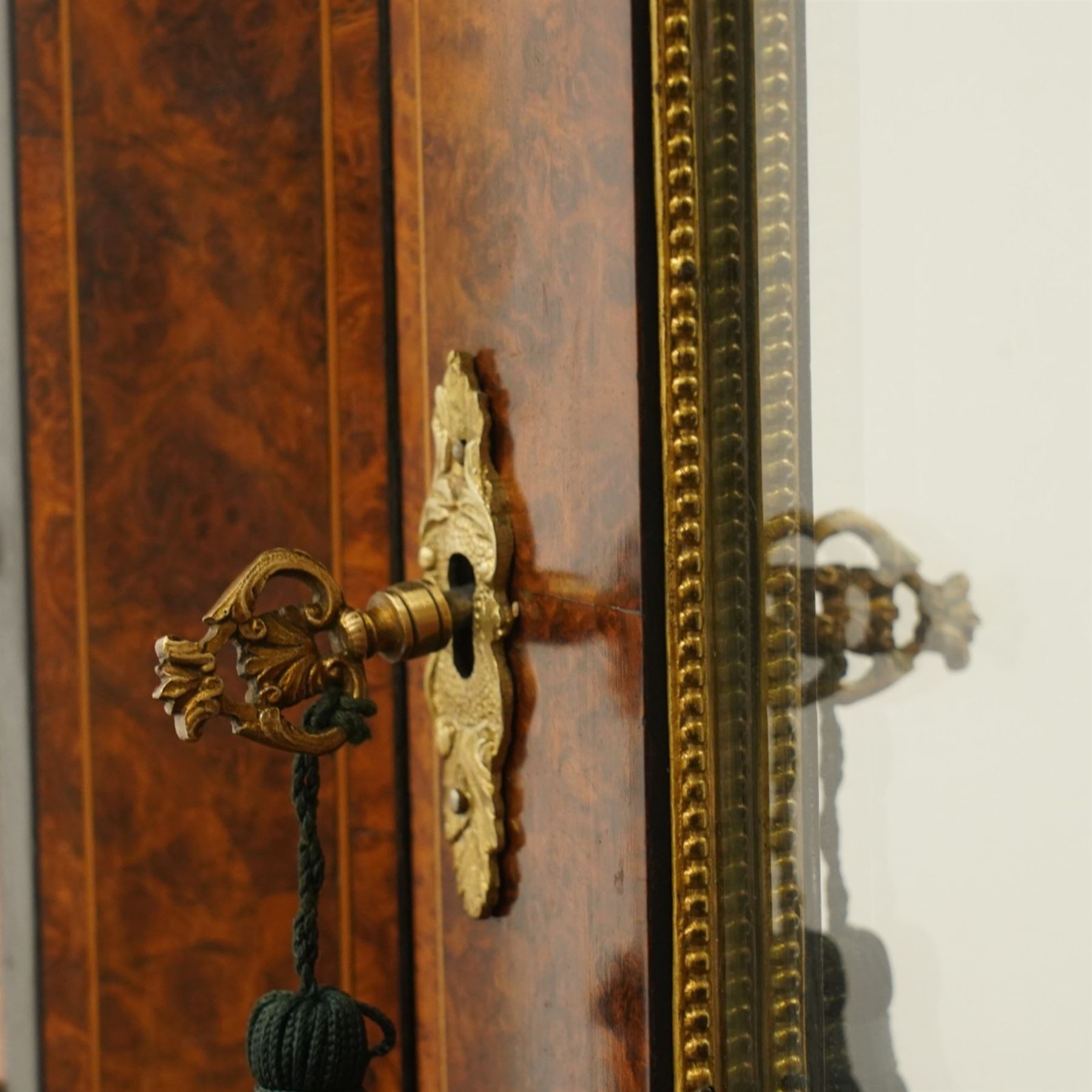 19th century French inlaid figured walnut and ebonised Bonheur de Jour or writing desk, the raised upper section with pierced brass three-quarter gallery, over a mirror glazed cupboard and a combination of drawers, the shaped and moulded top with leather inset and satinwood stringing, with brass beading too the ebonised edge, fitted with a serpentine fronted frieze drawer, raised on cabriole supports, inlaid throughout with scrolling foliate decoration in boxwood and ornate cast brass mounts and handles