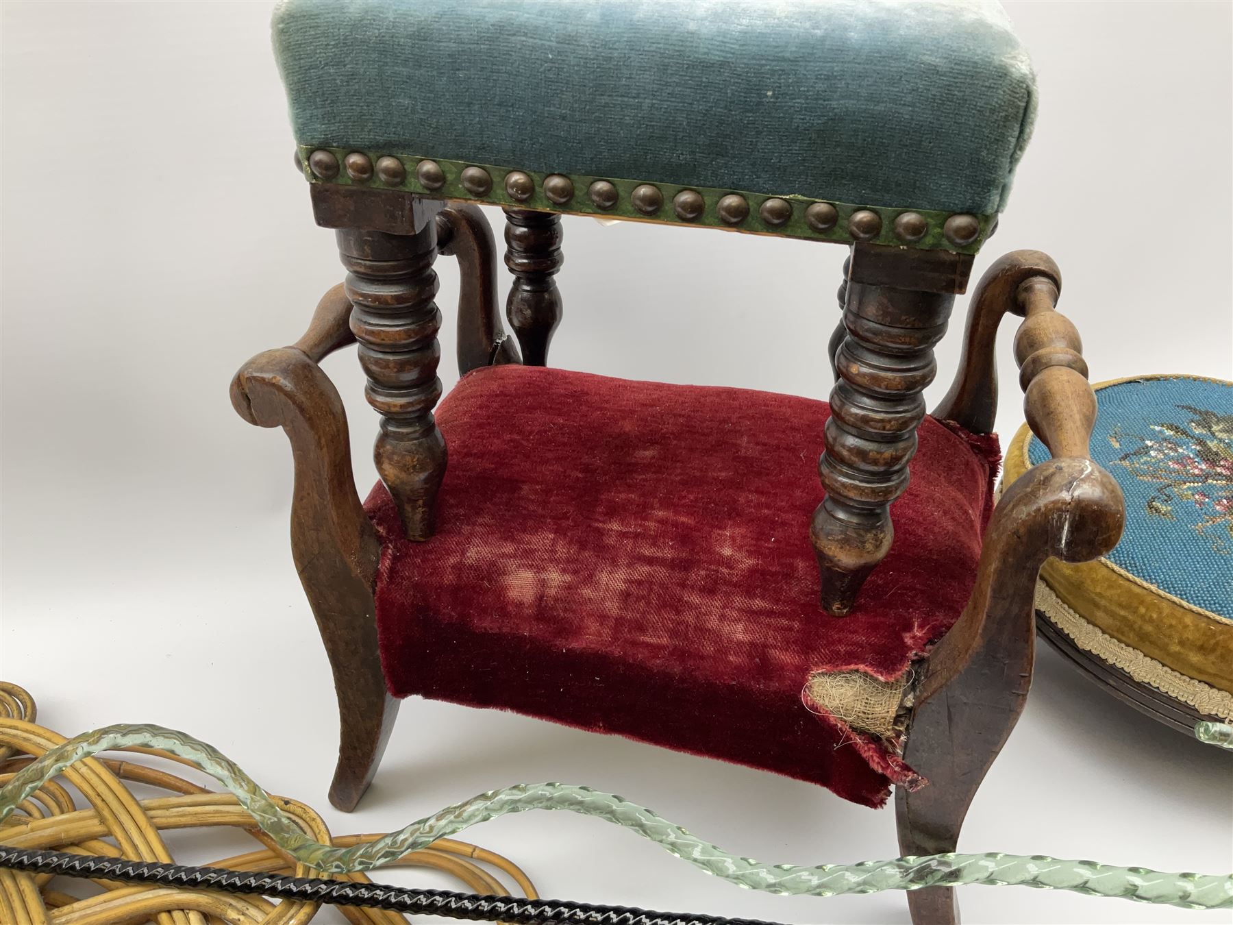 Victorian beadwork footstool with two other wooden upholstered footstools, one with turned bobbin legs, two Victorian glass frigger canes, one of twisted spiral form, and three carpet beaters