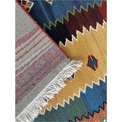 Late 20th century Louis De Poortere Belgian Shalamar wool ground rug, featuring a vibrant multi-coloured geometric design with stacked rectangular borders surrounding two central medallions, finished with fringed ends
