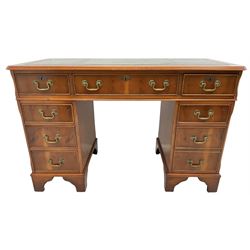 Georgian design yew wood twin pedestal desk, rectangular top with green leather inset writing surface, fitted with nine cock-beaded drawers, on bracket feet