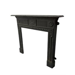 Adam design - cast iron fire surround, moulded rectangular mantel over central foliate urn and vertical flutes, flanked by C-scroll floral roundels, the aperture decorated with trailing bellflowers