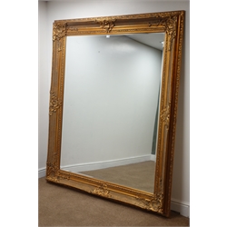 Large rectangular bevelled edge wall mirror in ornate swept gilt frame, 170cm x 200cm