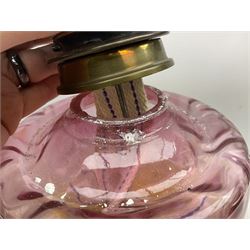 Victorian table oil lamp with black glazed stepped circular base, reeded brass column, moulded pink glass reservoir, duplex burner and frilled rim frosted glass shade with clear glass chimney H69cm