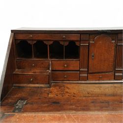 George III oak bureau, the fall front enclosing a fitted interior of small drawers and pigeonholes, above seven graduated drawers with brass plate handles and bone escutcheons, raised on bracket feet