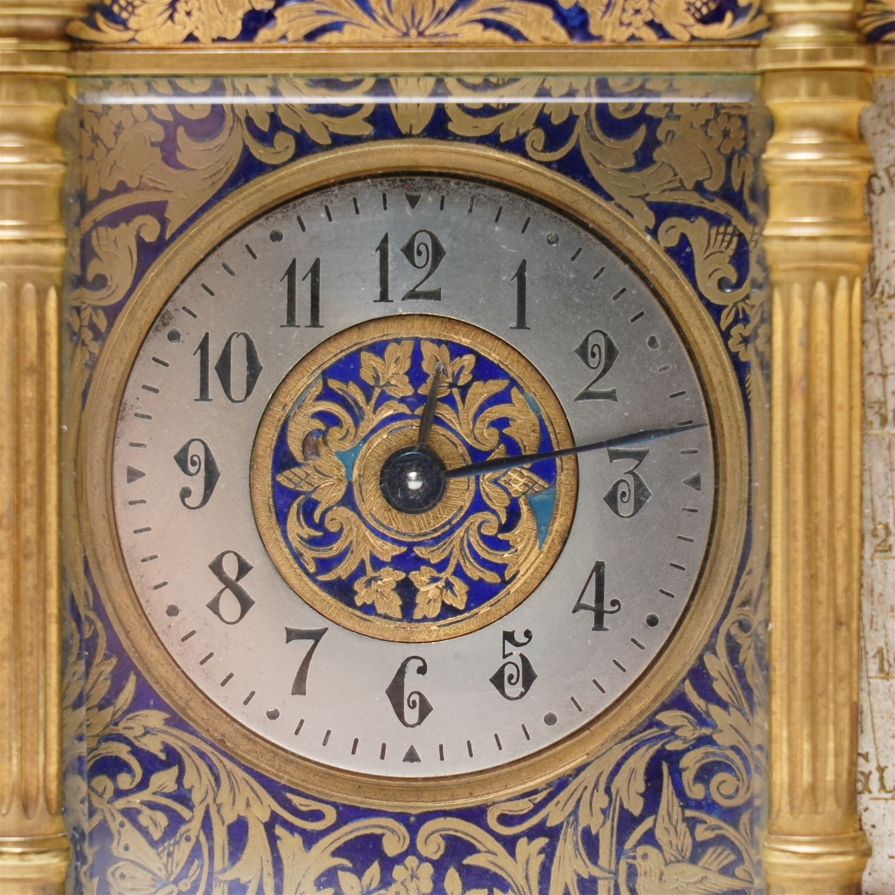 French-late 19th century combination brass carriage timepiece with barometer, thermometer and compass, with a fluted T bar handle and eight matching columns with turned finials, bands of fretted brass to the base and cornice and conforming decoration to the dial masks and dial centres, with silvered chapters to the time dial and barometer and a mercury thermometer between, the top with a circular bevelled viewing glass to the escapement and compass to the other, with a single train 8-day movement and cylinder platform escapement.  With key.