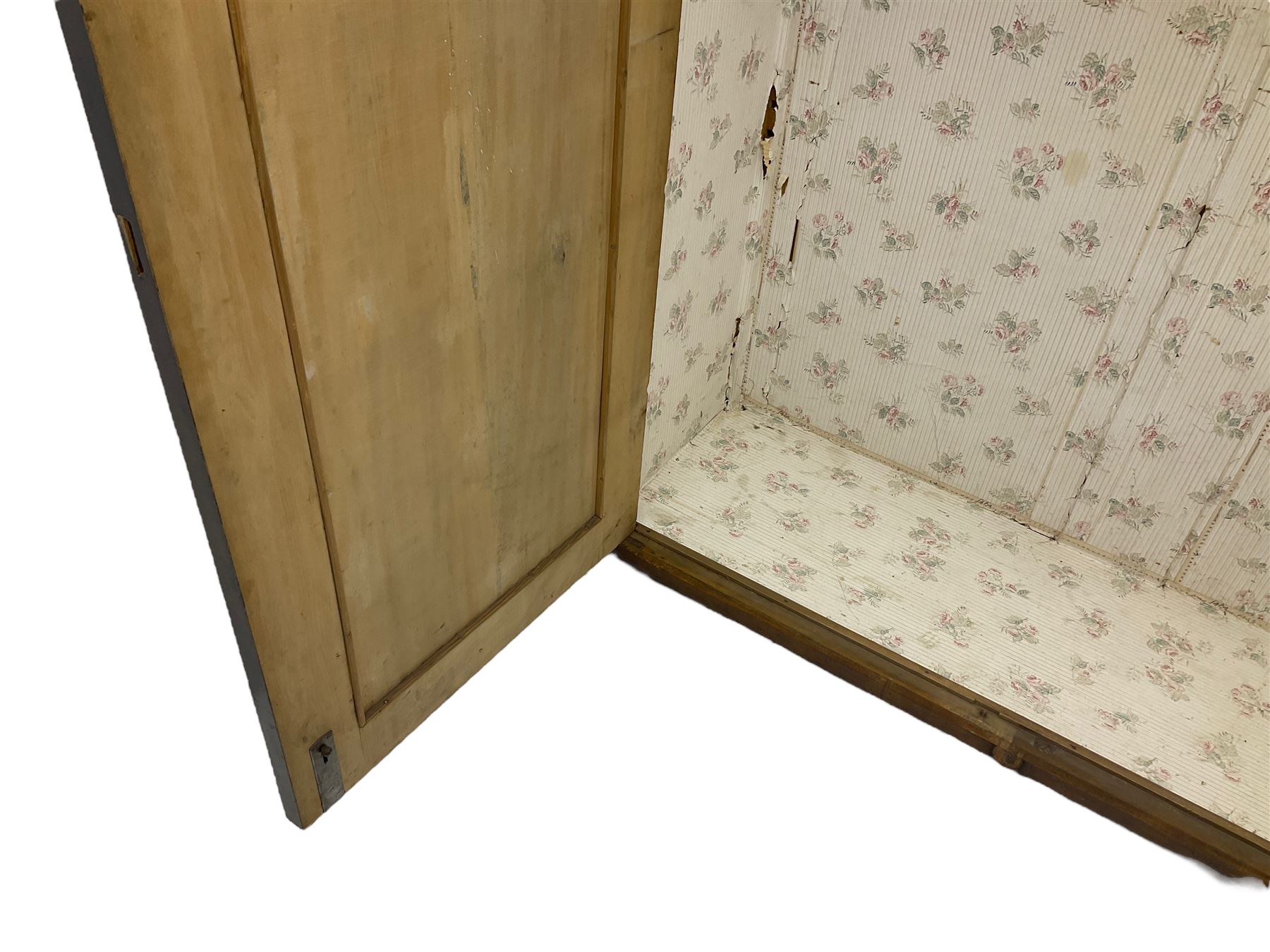 Early 20th century Italian walnut armoire wardrobe, the pierced and scrolling pediment carved with acanthus leaf detail, flanked by two scrolling cartouche with matching corbels below, the two panelled doors with applied carved rinceaux slips, with a central spiral turned upright, enclosing single shelf and hanging rail, raised on scroll feet