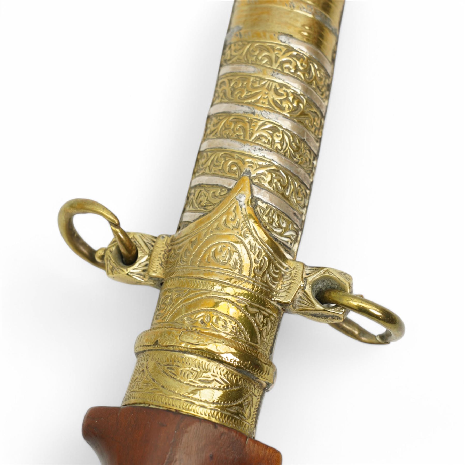 Moroccan jambiya, the metal scabbard decorated in gilt and silver and with hardwood grip L41cm overall