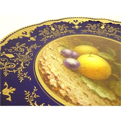  Early 20th century Coalport cabinet plate, the centre painted with a still life scene of plums and berries by Frederick Chivers, on a cobalt blue and gilded ground, signed to lower left F.H. Chivers, D23cm   