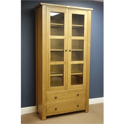  Willis & Gambier solid light oak bookcase display cabinet with glazed panel doors and two base drawers, W102cm, H199cm, D40cm  