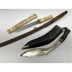 Japanese tanto dagger with 21cm steel single edged blade, the bone grip and saya with all-over carving of figures engaged in various pursuits, one reading a scroll with visible characters L39cm overall; together with another eastern short sword, lacking scabbard, and an Indian kukri in scabbard with one skinning knife (3)