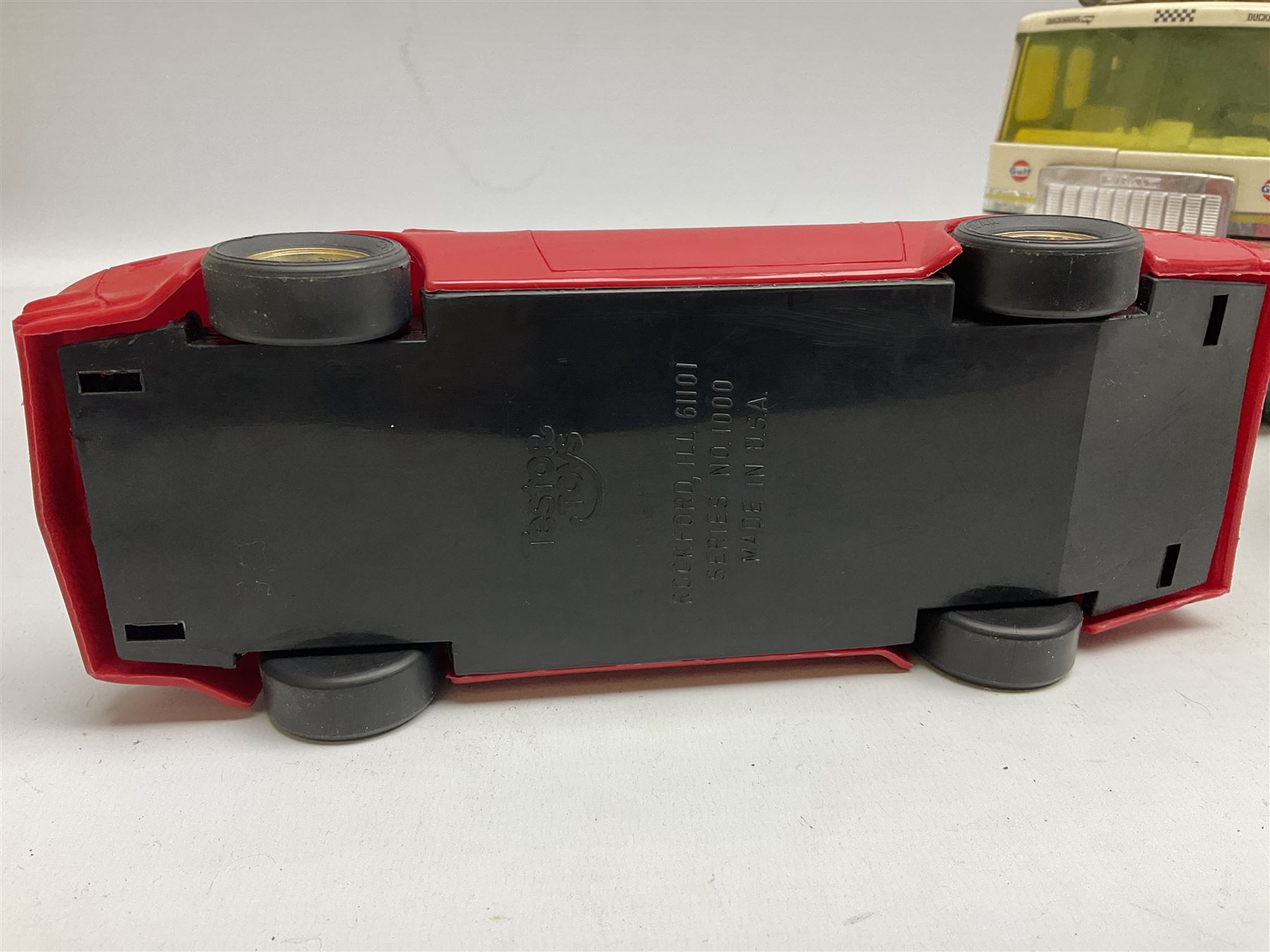 American Nylint large scale tin-plate car transporter L59cm carrying a Testor Toys plastic car; Tonka tin-plate mobile crane; boxed Sarony Cigarettes tin-plate roulette game with rules; and Japanese style tin-plate box, the lid inset with a revolving poker dice game (4)