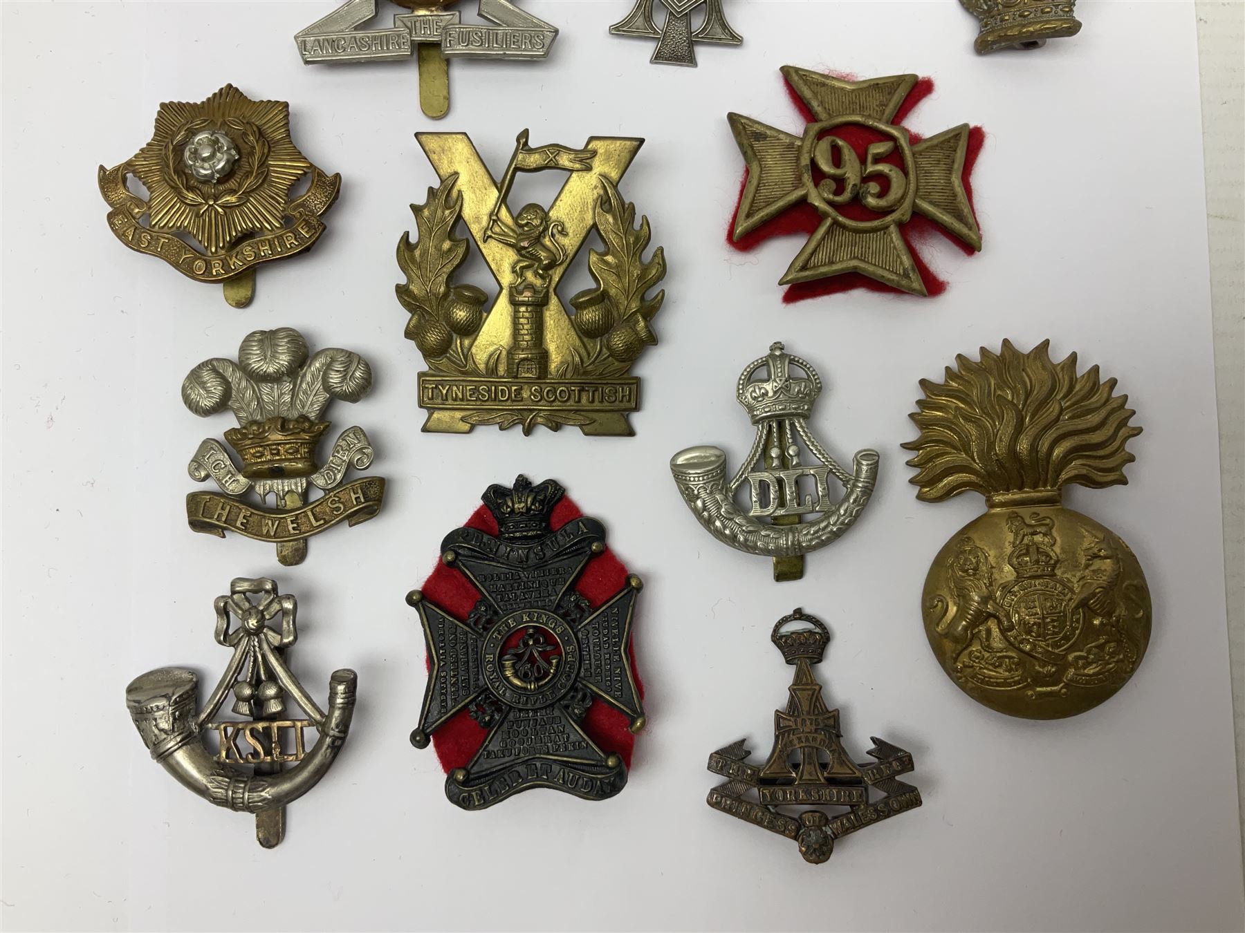 Over thirty regimental cap badges for fusiliers, Yorkshire interest, Light Infantry etc including Royal Scots and Welsh fusiliers, Durham L.I., KO Yorkshire L.I., Oxford & Bucks L.I., Green Howards, East Yorkshire, West Riding, York North Riding etc 