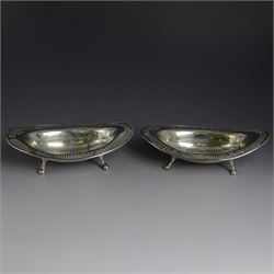 Pair of late Victorian silver bon bon dishes, of oval form with pierced rim, upon four paw...