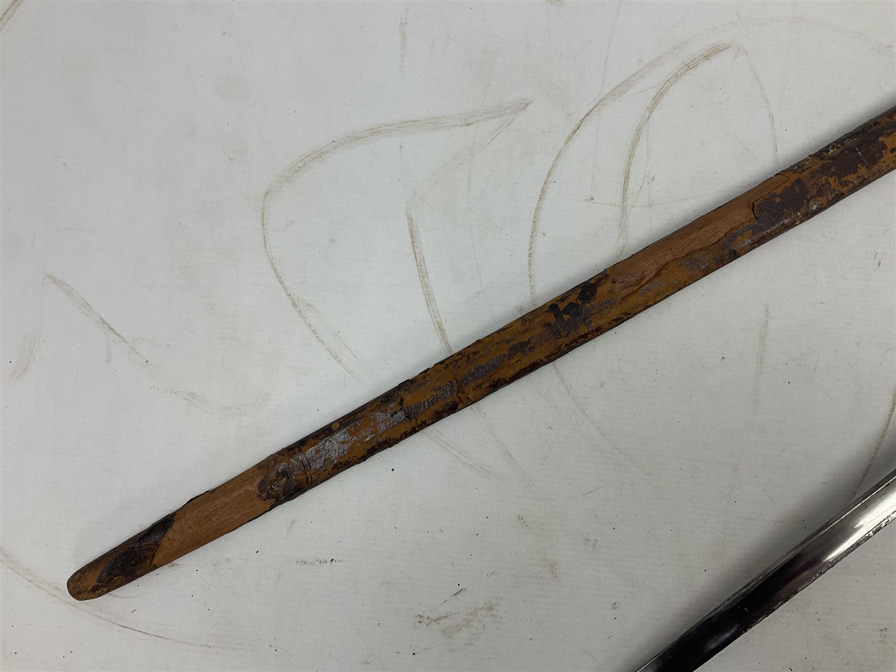 George V British Army 1897 pattern officers sword with plain 82cm fullered steel blade, pierced  basket hilt with George V cypher and wire bound leather grip with chequered backstrap; in leather covered field service scabbard L101cm overall; and another officer's sword in relic condition lacking scabbard (2)