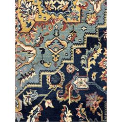 Belgian Sultan woollen ground rug, central navy field densely decorated with floral sprays and geometric patterns (192cm x 135cm); handwoven tribal terracotta ground rug (121cm x 71cm); Persian crimson ground runner, all over stylised floral and foliate motifs (266cm x 94cm)