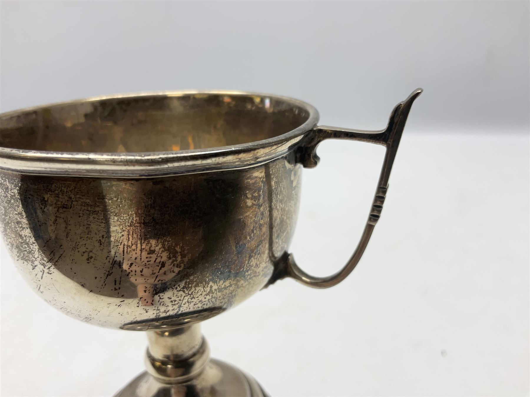 1930's silver twin handled trophy cup, upon black circular plinth, hallmarked Birmingham 1936, approximate silver weight 47 grams
