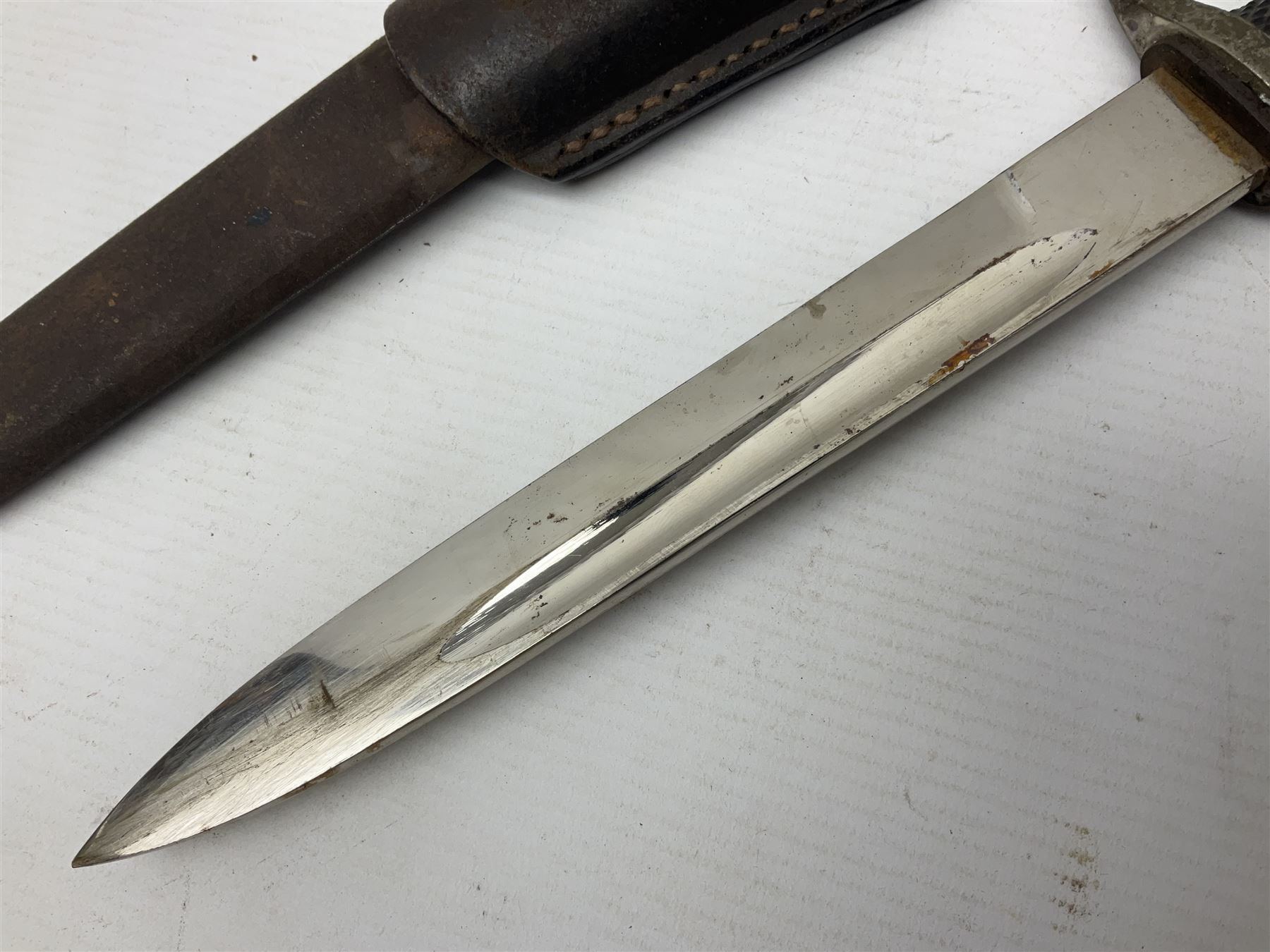 WWII German K98 (short) NCO dress bayonet, the 20cm fullered blade marked Anton Wingen Solingen to the ricasso, with chequered black grip plates; in steel scabbard with indistinctly stamped leather frog |L37cm overall