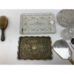 Glass dressing table tray, scent bottles and lidded bowl, metal mounted foliate design hair brushes and handheld mirrors etc