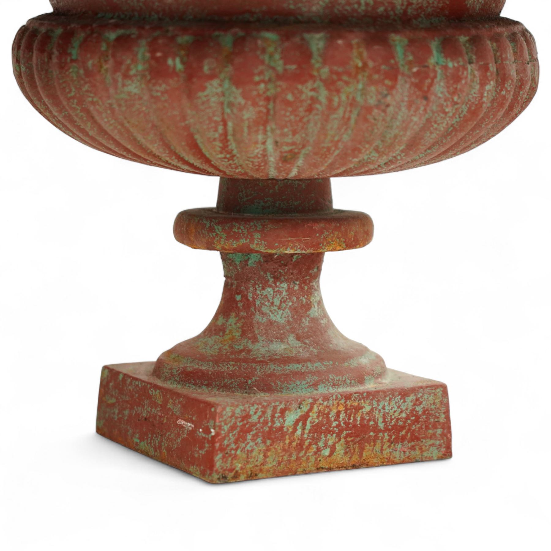 Pair of cast iron garden urns, each of flared form with crinkled edge rims and circular bodies, finished in aged red paint and raised on square bases