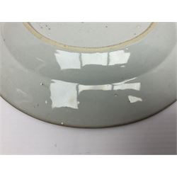 Three 18th century Chinese Famille Rose plates, the first example enamelled with blossoming peonies, rockwork and fence, the other two examples of similar design, decorated with blossoming peonies and sprigs within shaped inner borders, each approximately D23cm