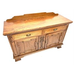 Edwardian oak sideboard, raised and shaped back, two short drawers above two cupboard doors enclosing fitted interior, shaped bracket supports