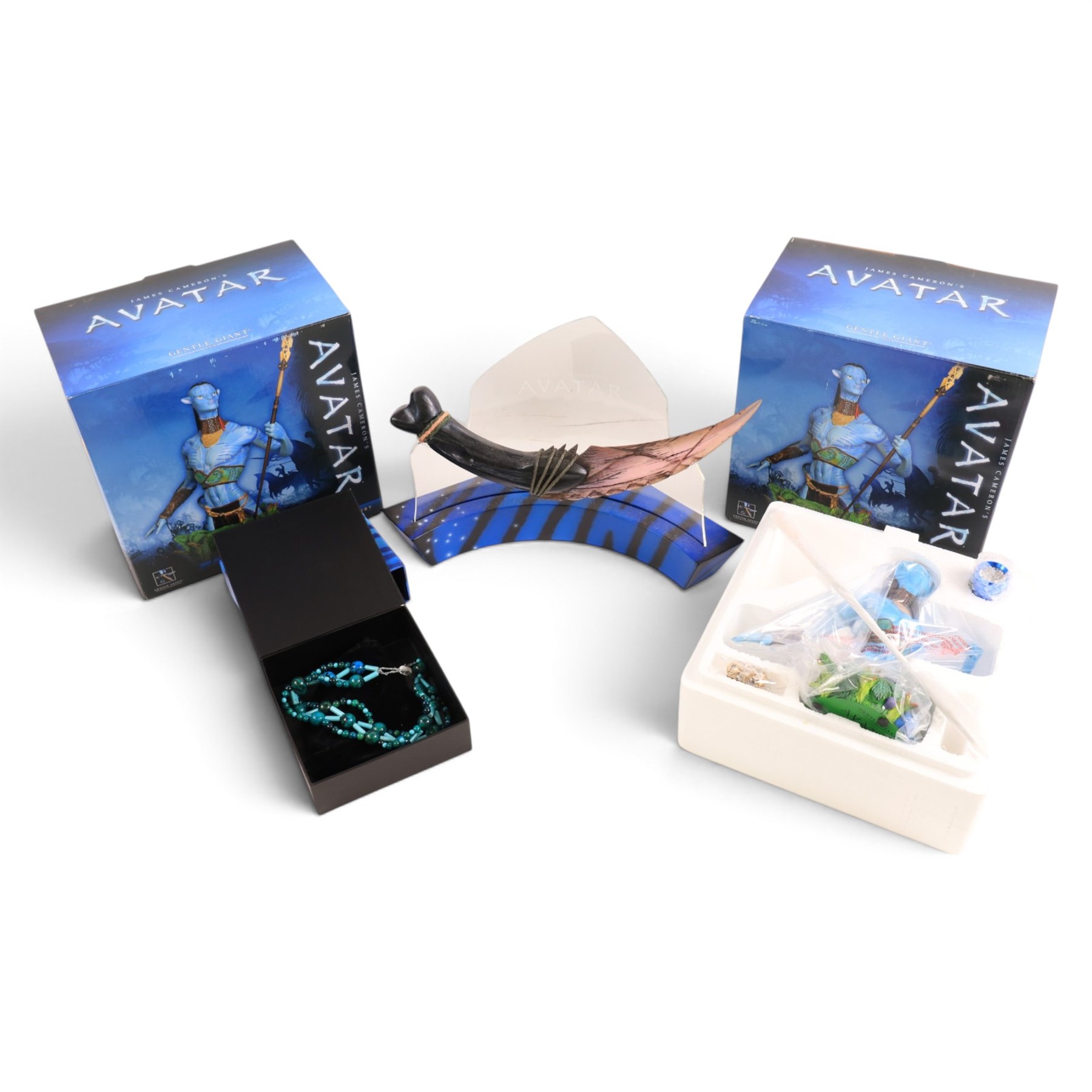Two limited edition Gentle Giant Avatar 'Tsu'tey' Collectible Mini Busts, both boxed, together with an Avatar choker/bracelet and The Noble Collection Na'vi resin dagger replica on curved display stand