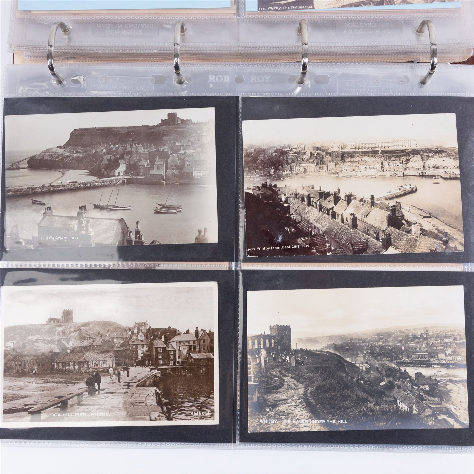 Two-hundred and thirty eight early 19th century to 20th century Whitby view postcards, including twenty-four early 19th century court cards, seventeen views of Whitby Abbey, forty depicting the fishing fleet and harbour, with a selection of cards providing a detailed study of the early 'Yards' the fisherman's dwellings around the harbour, all housed within a Stanley Gibbons Picture Postcard Album