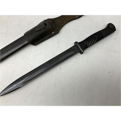 German Model 1884/98 knife bayonet, Third Reich period, with 25cm fullered steel blade; in steel scabbard with leather frog L41cm overall; and German Ersatz bayonet in steel scabbard marked Waffenfabrik Mauser A.G. Oberndorf & N (2)
