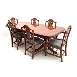 Yew wood twin pedestal extending dining table, shaped supports and brass castors (W216cm, D100cm, H77cm) and six (4+2) chairs, shaped back and upholstered in patterned fabric raised on fluted supports (W52cm)