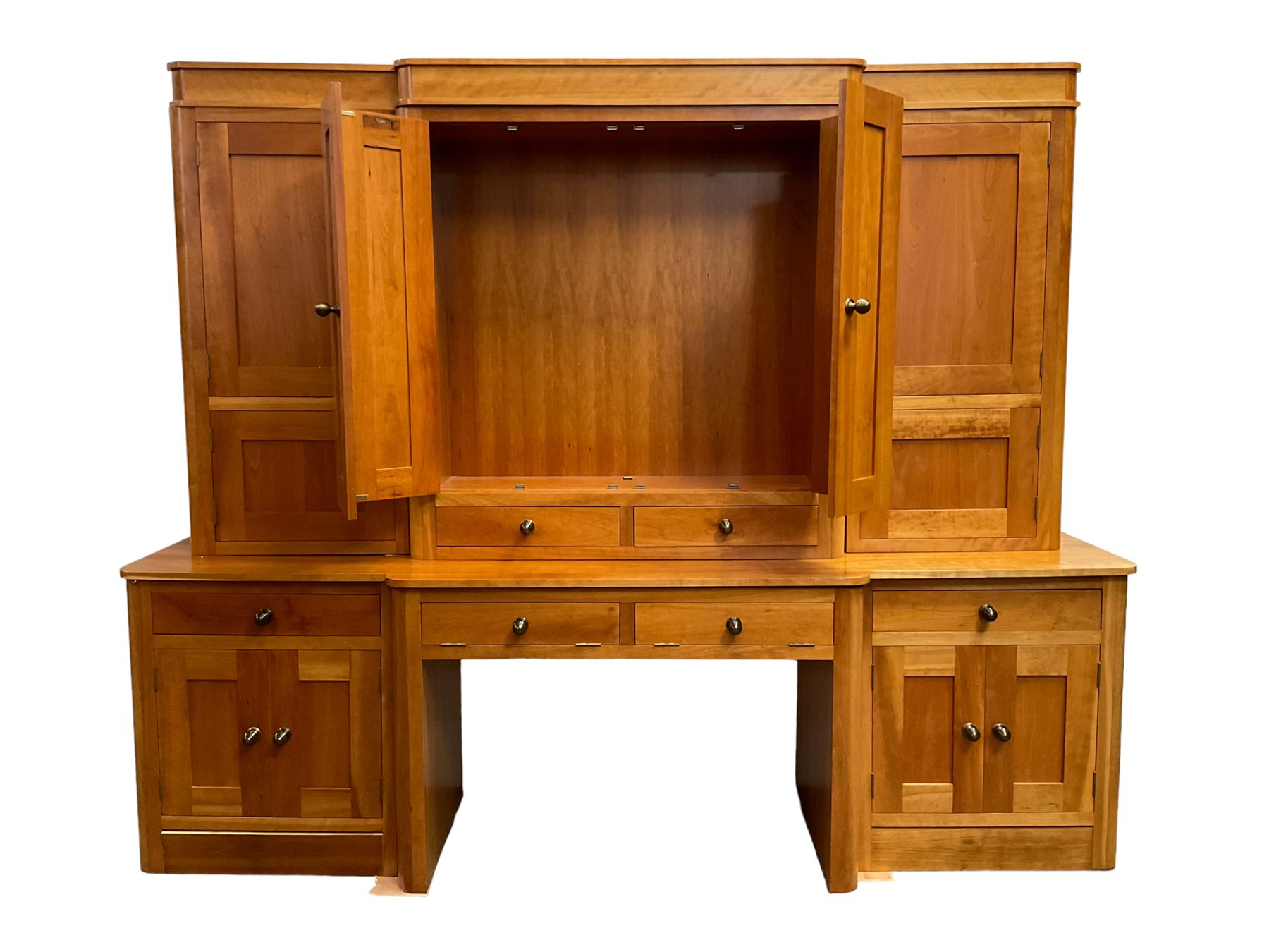 Large contemporary cherry wood break-front wall unit, the banded cornice over double cupboard with bifold doors and two drawers, flanked by four single cupboards, the base fitted with four drawers over four cupboards (W263cm, H216cm, D68cm); and a cherry wood cabinet, fitted with double cupboard over two short and two long drawers, with faux drawer facias (W81cm, H138cm, D66cm)