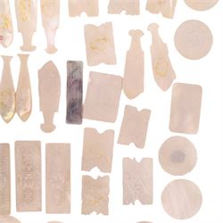 Collection of approximately sixty mother-of-pearl gaming tokens, including fish-shaped, rectangular, circular examples 