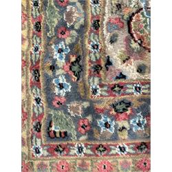 Persian design ivory ground rug, overall floral design with shaped central medallion, the main border decorated with trailing flower head pattern, within guard stipes 