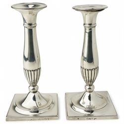 Pair of George III silver candlesticks with baluster stems and square bases, engraved with...