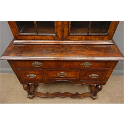  19th century Queen Anne style figured walnut twin arched cabinet on stand, two stepped glazed doors enclosing three shelves, above five drawers on turned supports and feet joined by shaped stretchers, W104cm, H218cm, D43cm  