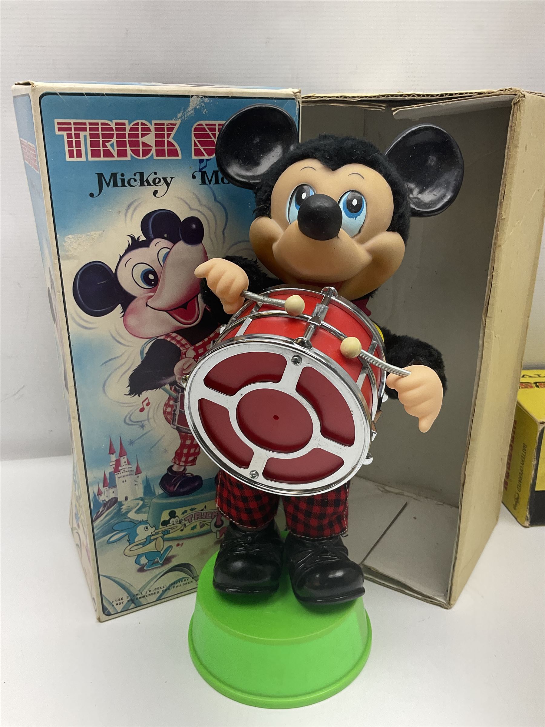 Mickey Mouse Trick Star battery operated drummer figure; Illco Mickey Mouse battery operated Fun Castle Roller Coaster; battery operated Western Express Locomotive; and JK Wells Fargo Overland Stage scale model; all boxed (4)