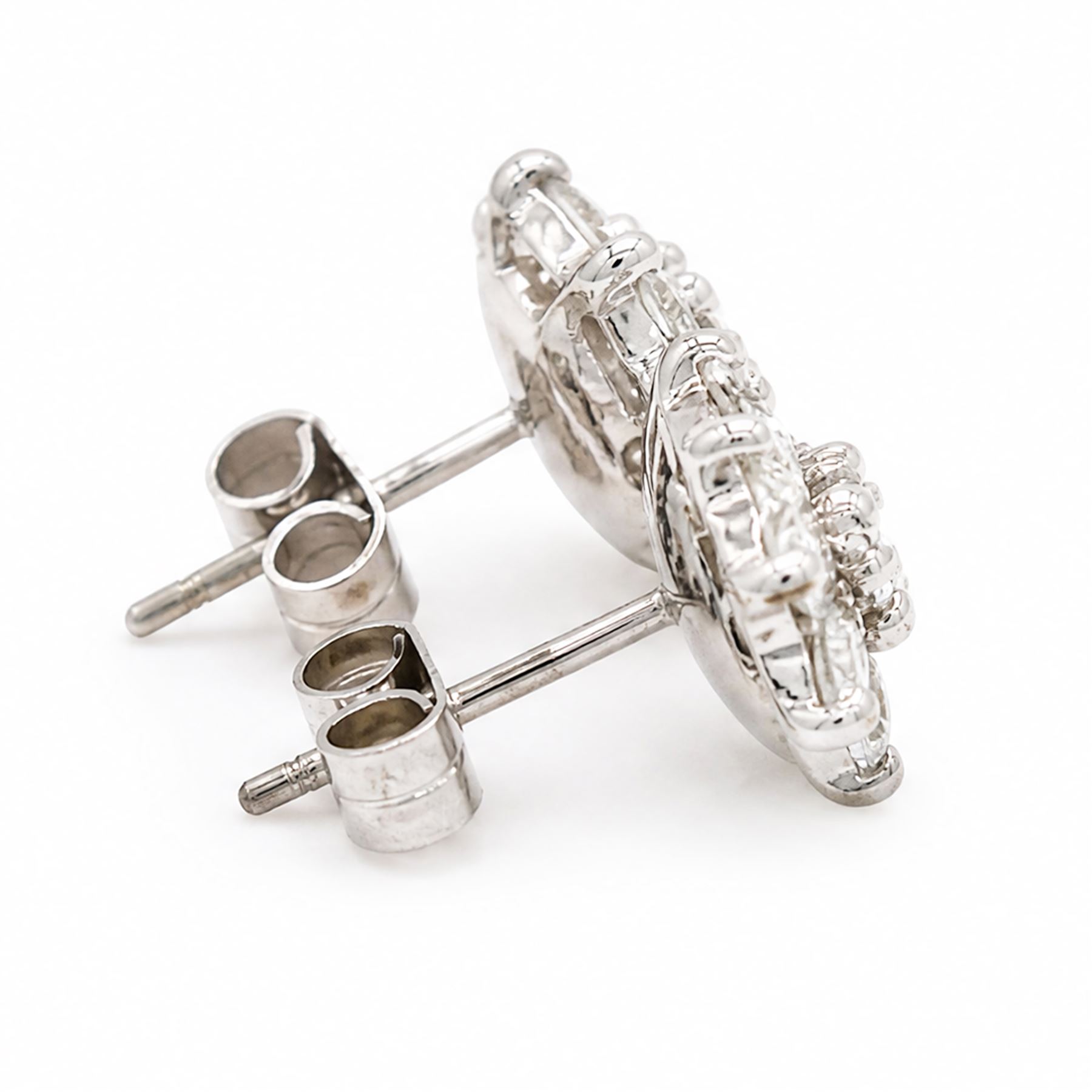 Pair of 18ct white gold diamond flower head earrings, each stud set with nine round brilliant cut diamonds, Birmingham 1996, total diamond weight approx 1.20 carat