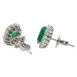 Pair of 18ct white gold oval emerald and round brilliant cut diamond cluster stud earrings, stamped, total diamond weight approx 0.80 carat, total emerald weight approx 2.75 carat