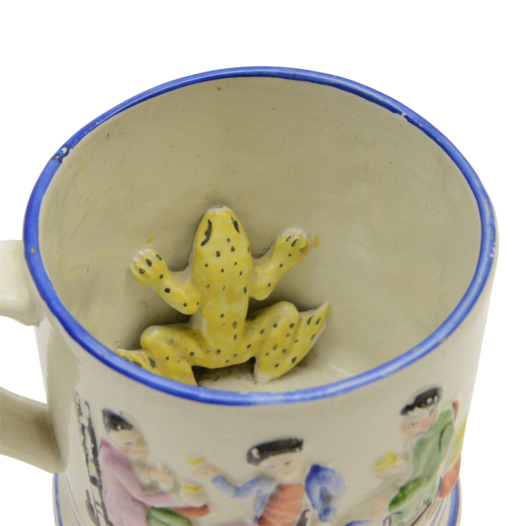 19th century frog and newt cup, decorated with a house in a landscape and cows, featuring a frog and newt inside the cup, together with three other frog cups 