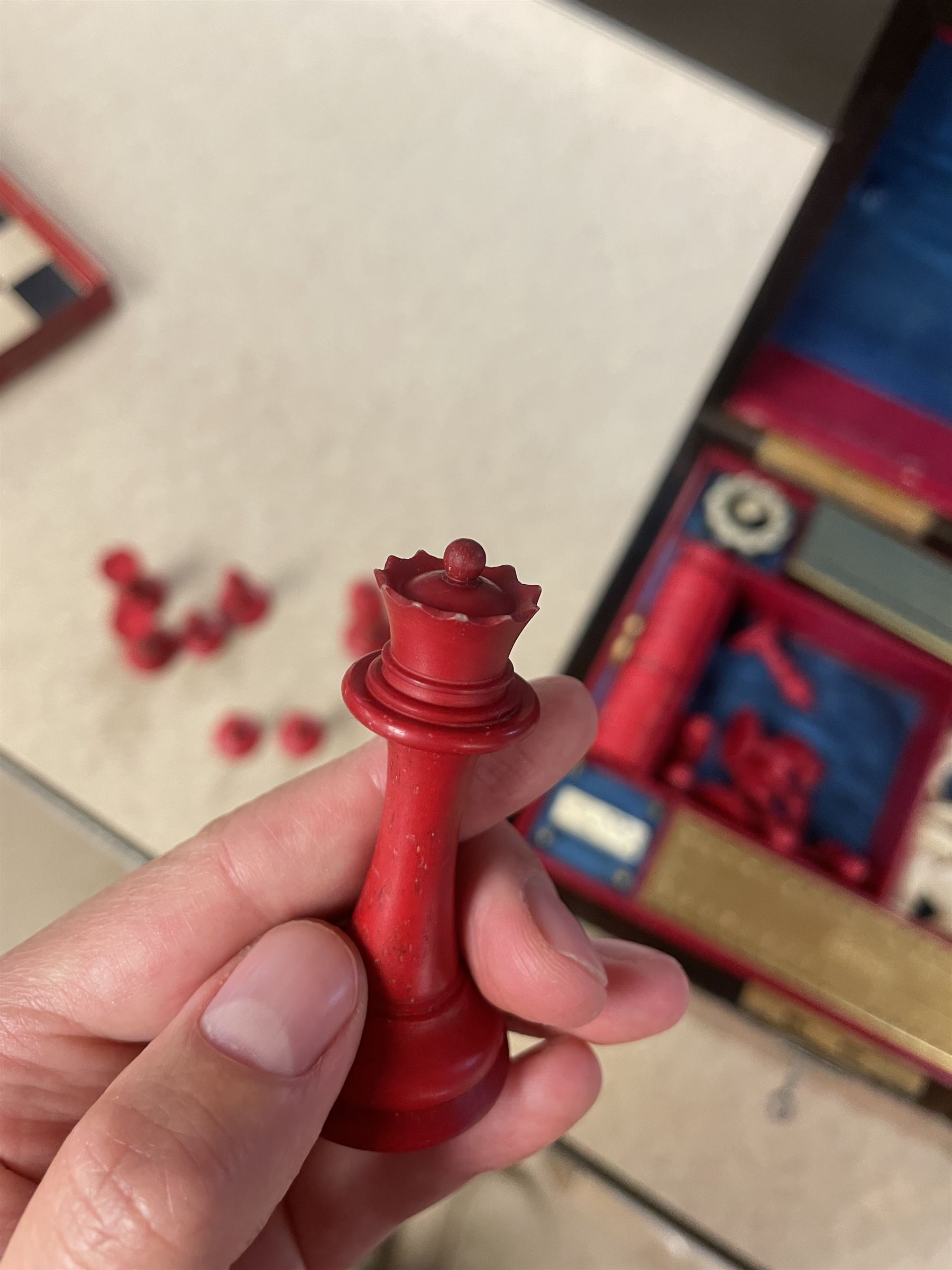 19th century walnut and brass bound games compendium box, painted to enhance the grain, of rectangular form, the hinged opening cover with rounded sides, central brass cartouche with engraved lion crest, and brass riveted straps, opening to reveal a red leather and blue silk lined compartmented interior, with fold-down games board, and lift-out tray containing playing cards, ebony turned dice towers, white and red stained bone draughts, and chess pieces, ivory dice, and ivory and ebony whist markers, and brass bezique board, cribbage board and markers, H15cm W32cm D24cm
This lot has been registered for sale under Section 10 of the APHA Ivory Act