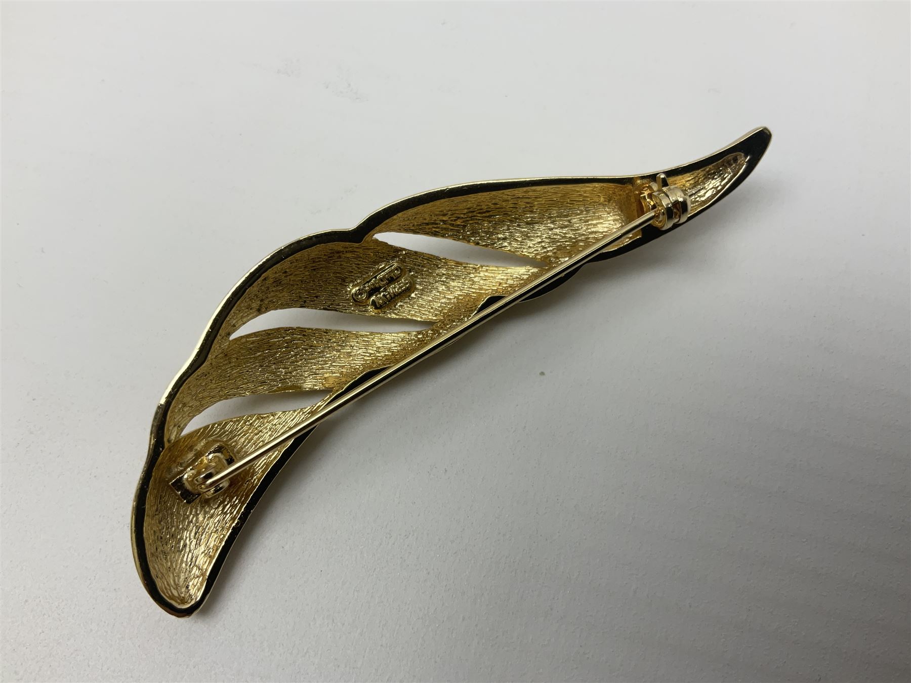 Christian Dior costume jewellery, comprising pair of pearlescent clip on earrings, enamel and paste leaf brooch and a pierced stylised leaf brooch, each stamped Chr.Dior Germany and in original boxes