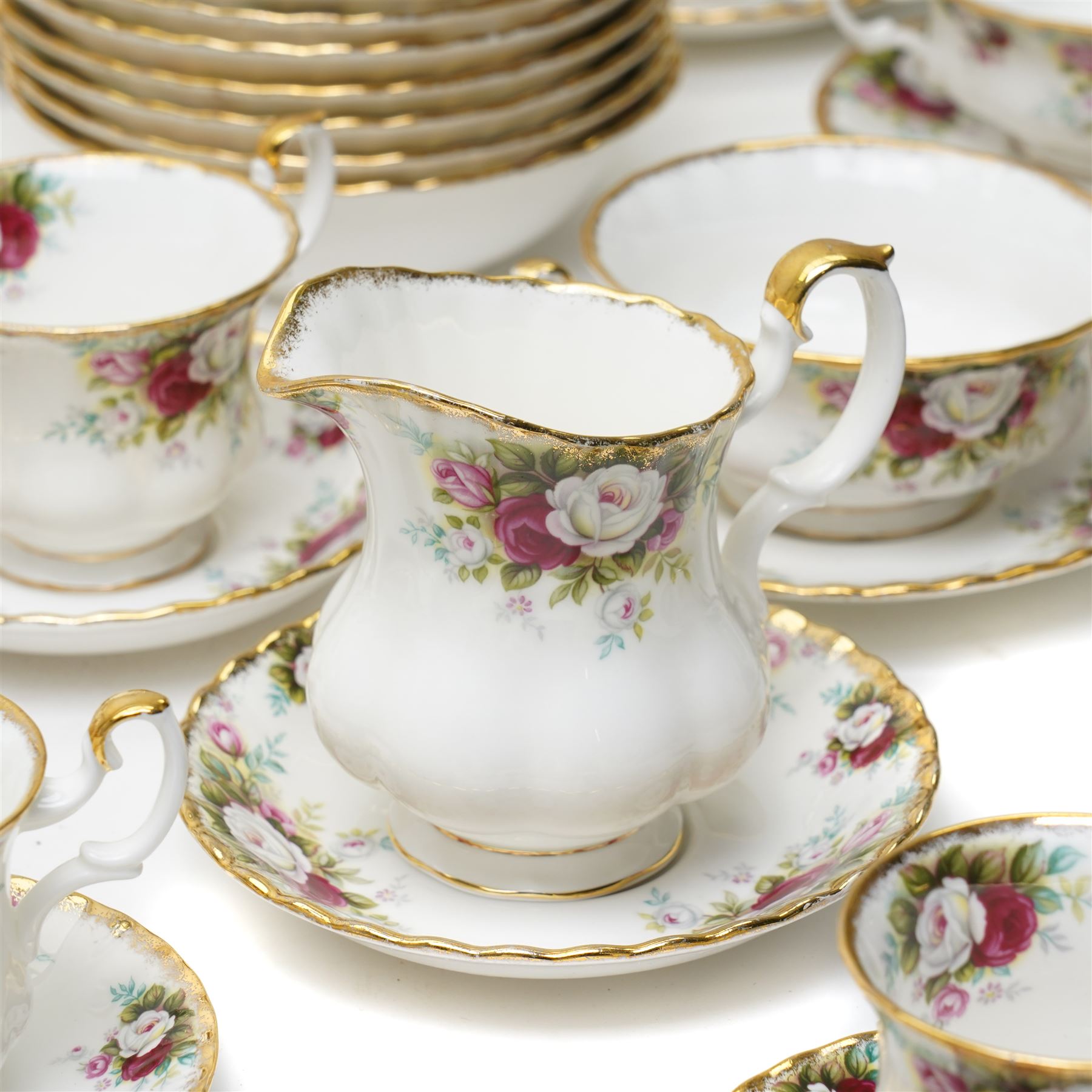 Royal Albert Celebration pattern tea and dinner wares, comprising covered tea and coffee pot, seven dinner plates, oval serving dish, gravy boat and saucer, nine coffee cups and ten coffee cup saucers, seven teacups and eight teacup saucers, eight soup bowls and saucers, rectangular serving tray, ten side plates, etc, approximately 88 pieces in total
