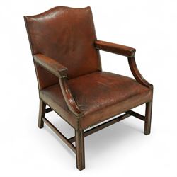 Early 20th-century Gainsborough-style library armchair, padded back, arms, and seat, brass button upholstered in brown leather, on square tapered front legs united by a stretcher 